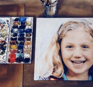 Portrait of a laughing little blonde girl by Maryanne Chisholm